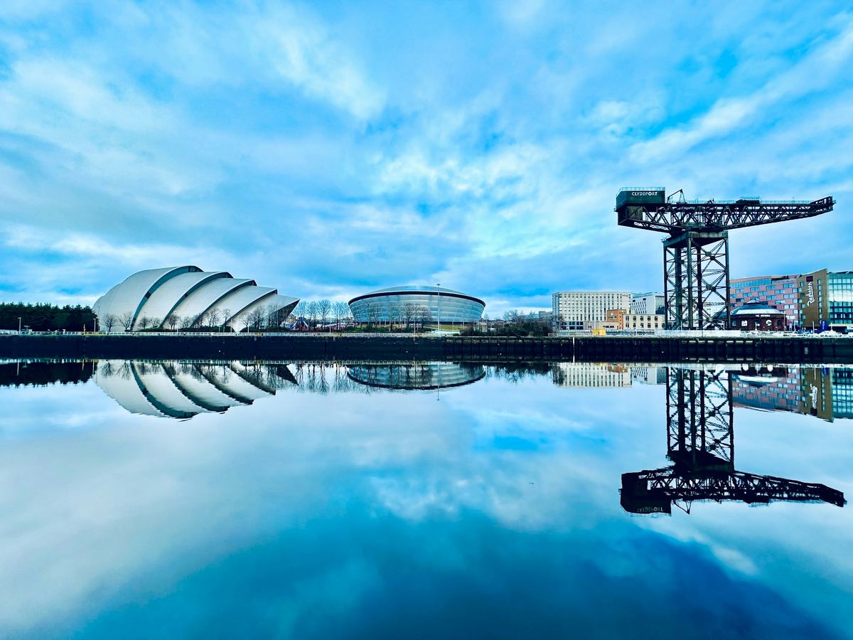 The SEC Armadillo, OVO Hydro and Finnieston Crane mirrored in the River Clyde, Glasgow.