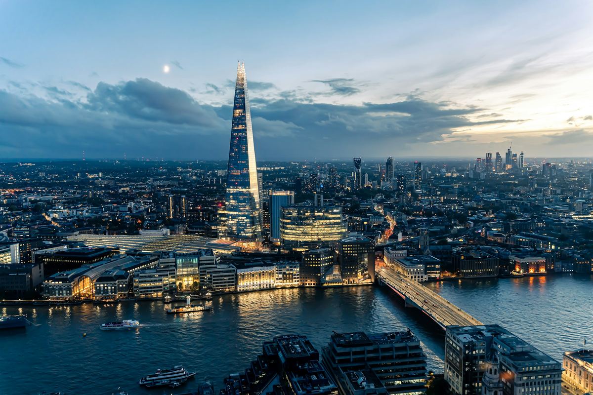 The London skyline at dusk seen from the Sky Garden, with the Shard and London Bridge over the Thames.