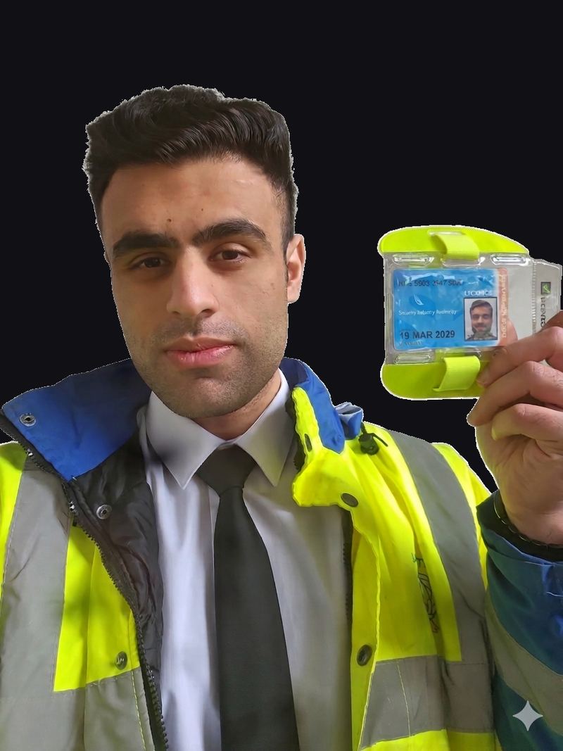 A Seccuro security officer in a hi-vis jacket holding up his SIA licence.